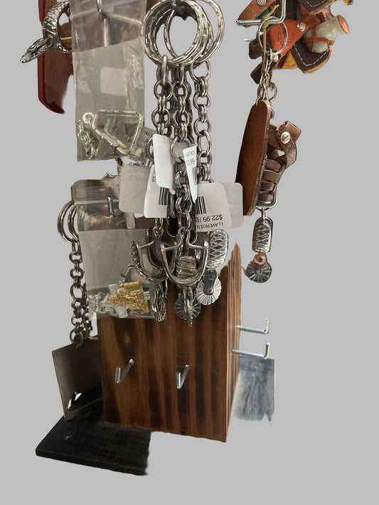 Silver chain jewelry on display with a blurred store background